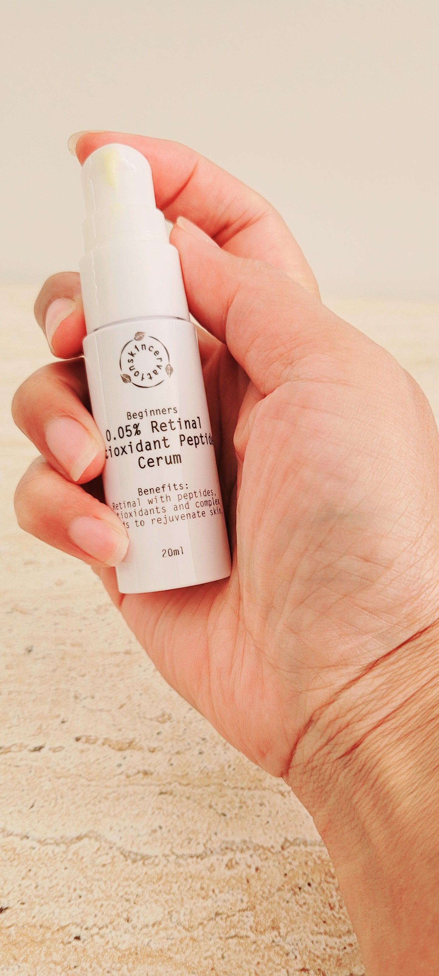 Hand holding Travel Size Intermediate Retinal Antioxidant Peptide Serum