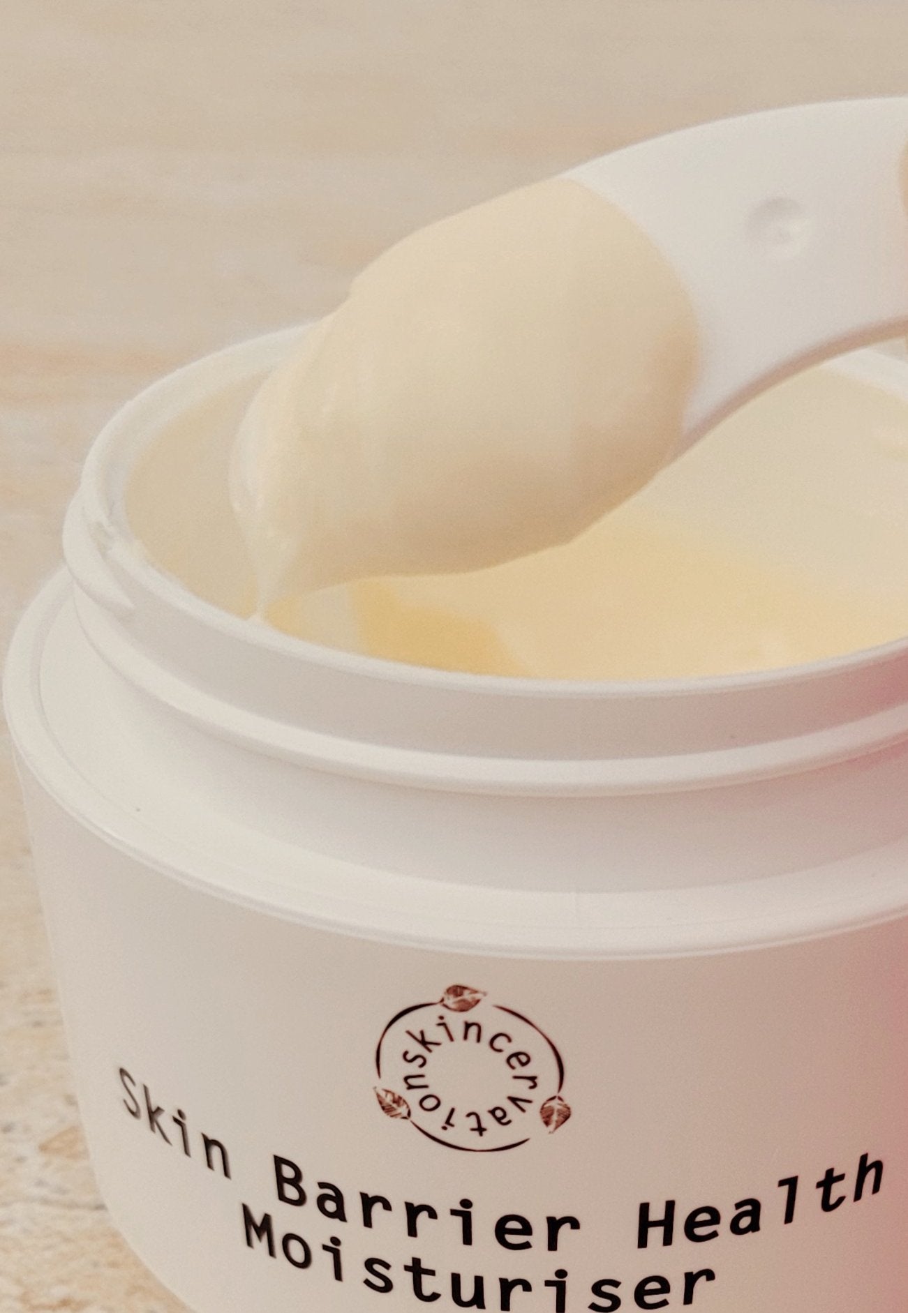 Skincervation Skin Barrier Health Moisturiser cream texture in a white jar with applicator scoop