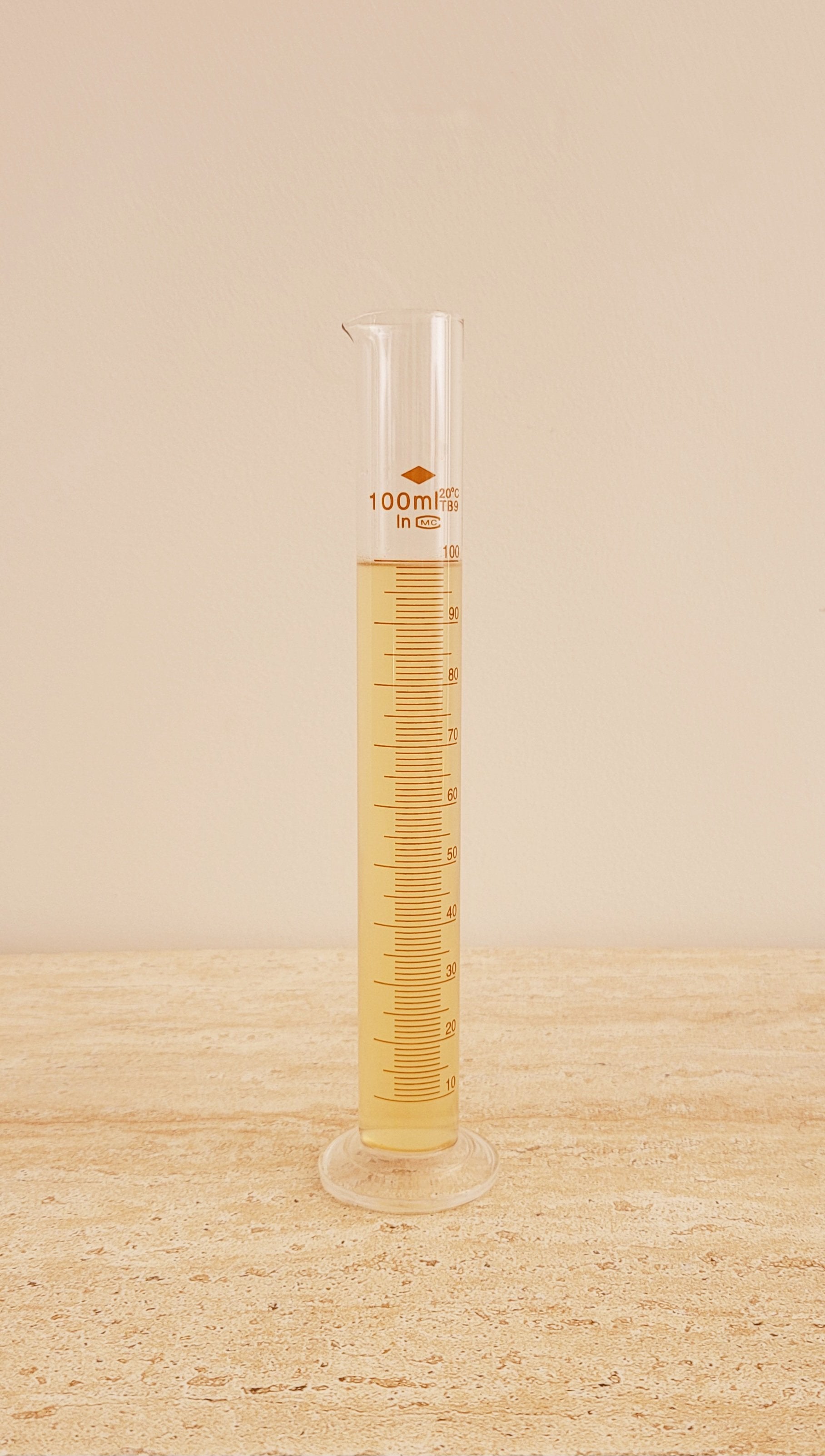 A scientific beaker filled with Hydration Essence Liquid