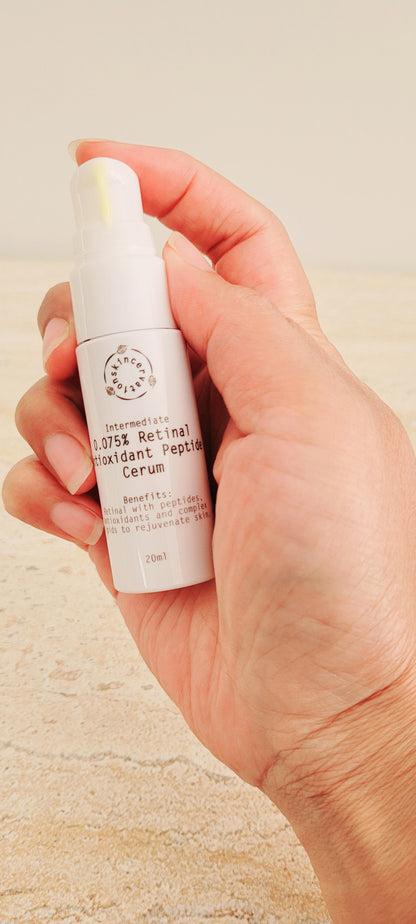 Hand holding skincervation Intermediate Retinal Antioxidant Peptide Anti-Ageing serum bottle