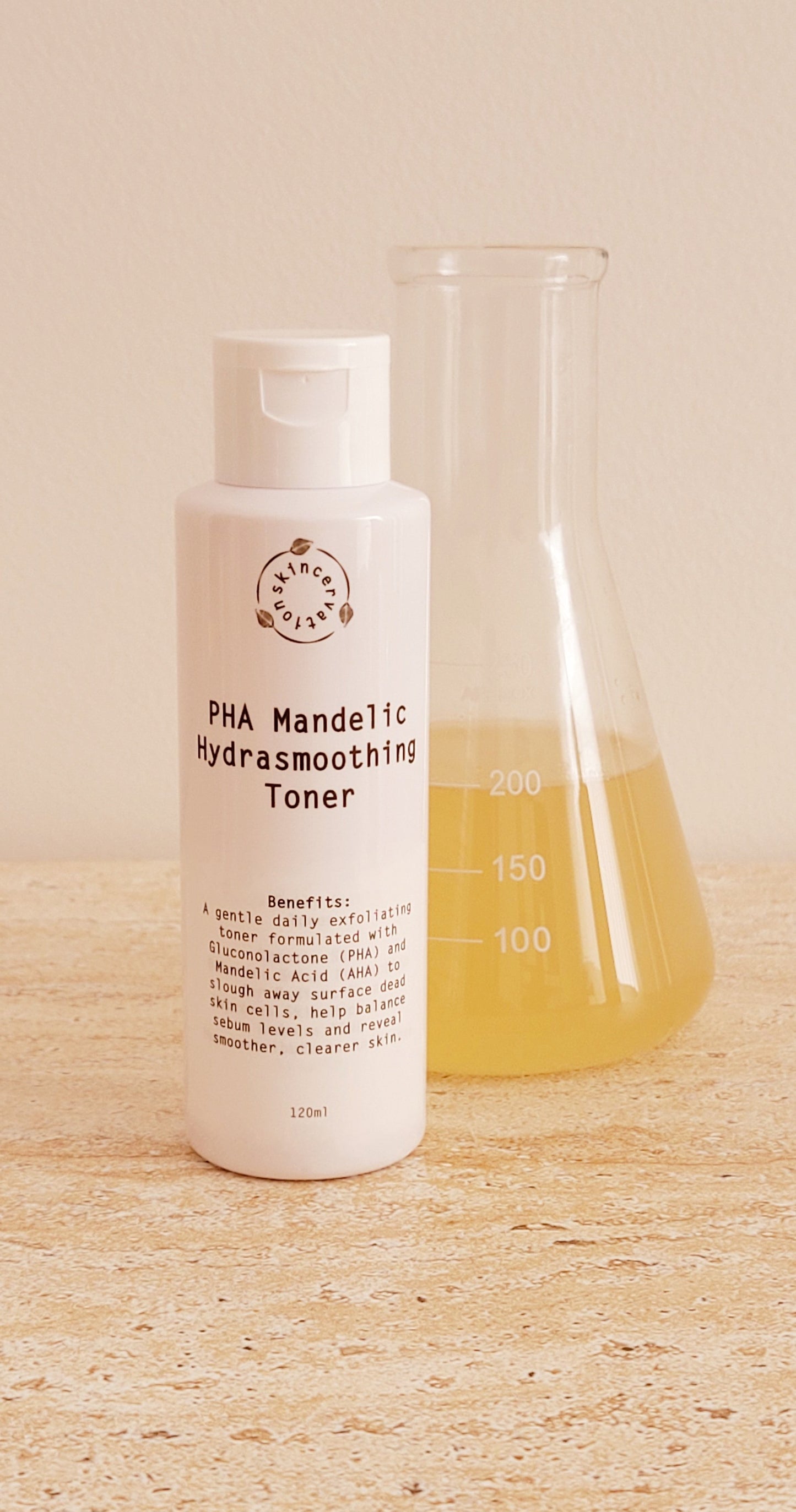 Skincervation PHA Mandelic Exfoliation Toner sensitive skin bottle next to a glass beaker with yellow liquid